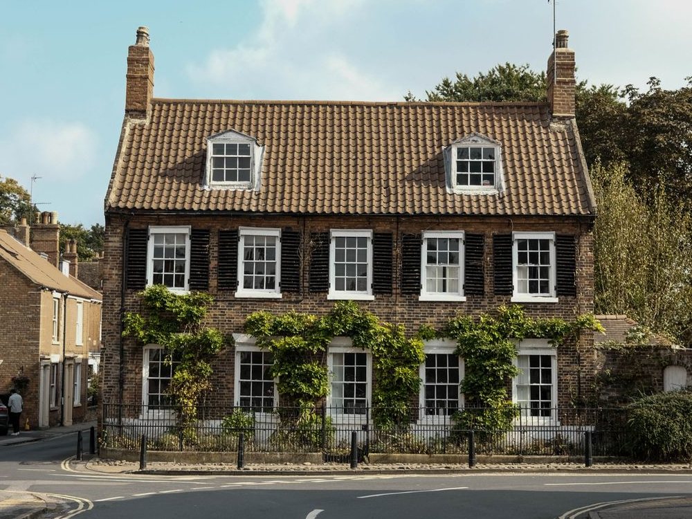 Traditional English brick house with a tiled roof and sash windows
